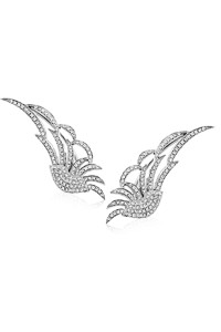 Wing like stud earrings crafted out of precious white gold and a multitude of tiny diamonds along the curves and lines that make it appear like wings