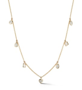 a bezel-set station necklace from Beny Sofer features diamond accents.