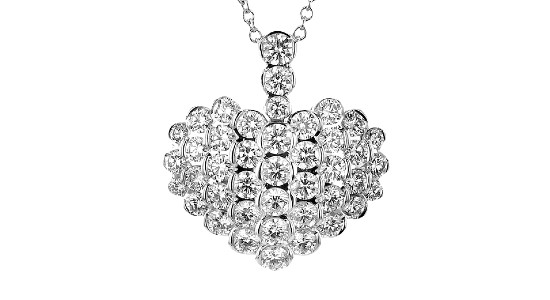 a diamond-studded, heart-shaped pendant necklace in white gold