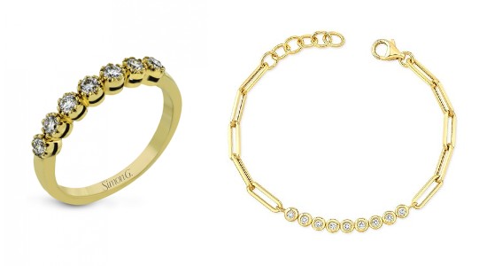 a yellow gold diamond fashion ring next to a yellow gold diamond chain bracelet.