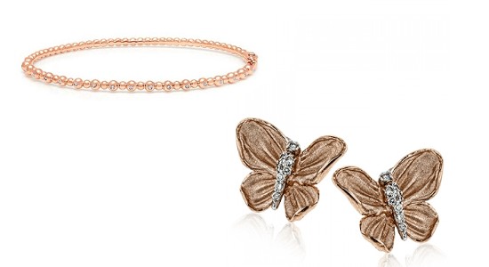 a rose gold bangle bracelet next to a rose gold pair of butterfly studs.