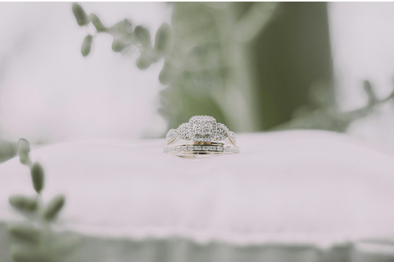 A close-up of a matching bridal set displayed on a delicate white cushion.